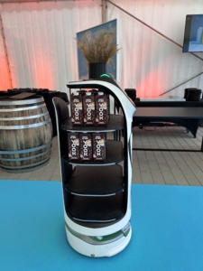 BellaBot service robot serving drinks to guests at the opening of the YOOK oat milk factory.